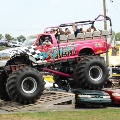Virginia Giant carries passengers overtop of other cars at Carlisle Truck Nationals.